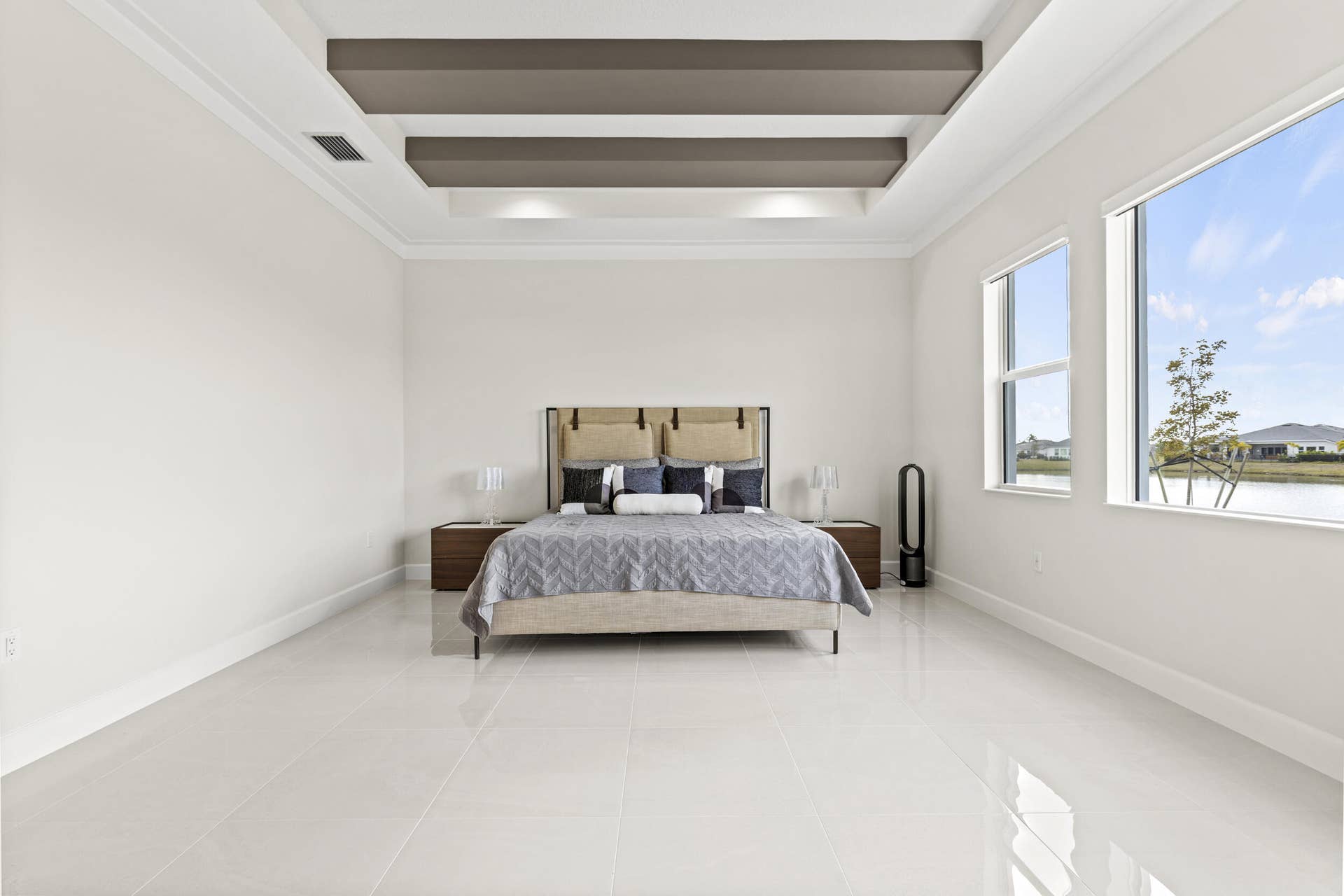 14976 Woodlot Court, Westlake, FL 33470 Owner's Suite featuring recessed lighting, tray ceiling, crown molding, expansive windows, polished tile flooring
