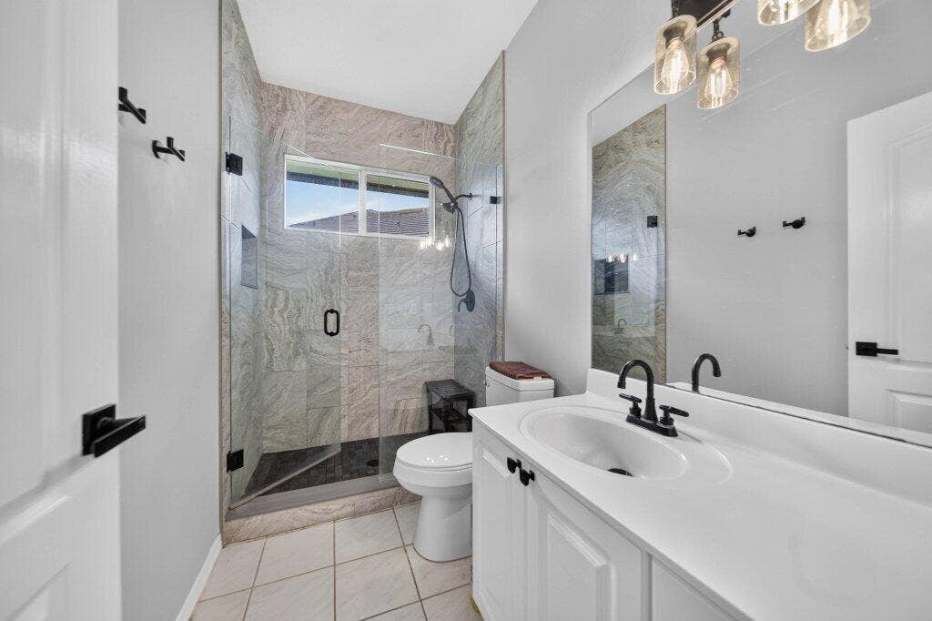 Frameless glass shower enclosure with tile surround