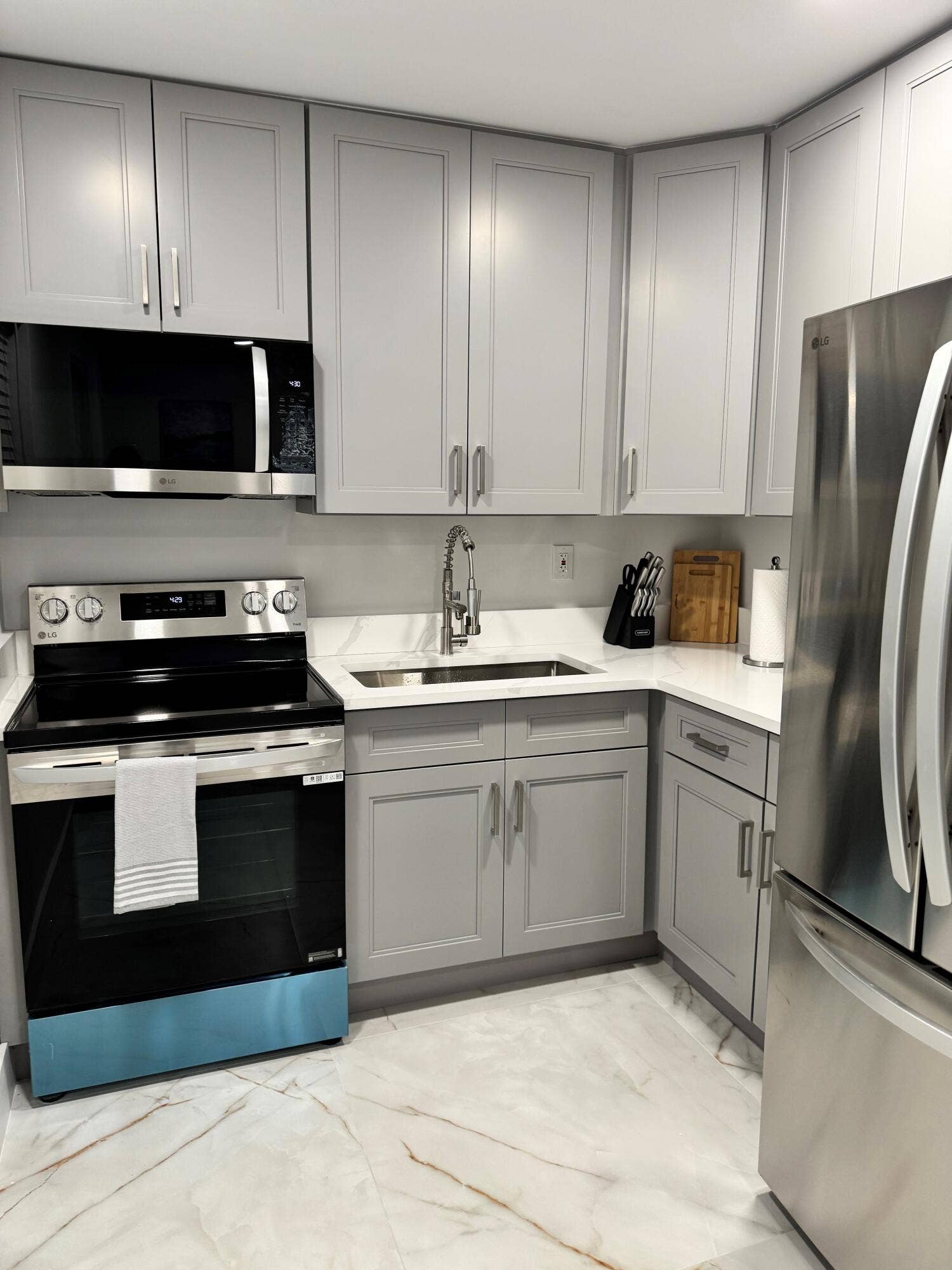 Updated kitchen with modern white cabinetry, sleek hardware, and a contemporary finish