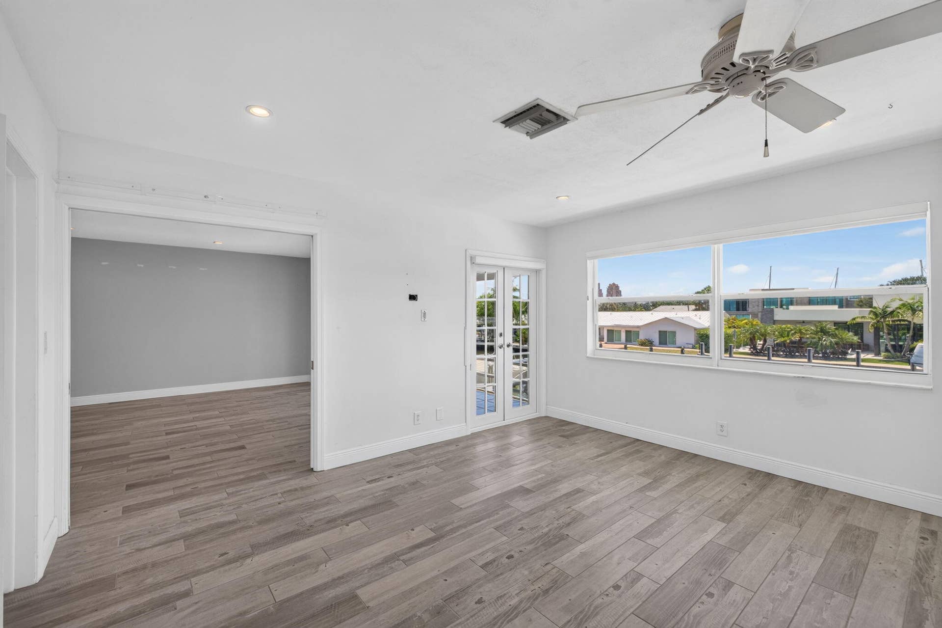 Wood-finish flooring, recessed lighting, and a ceiling fan