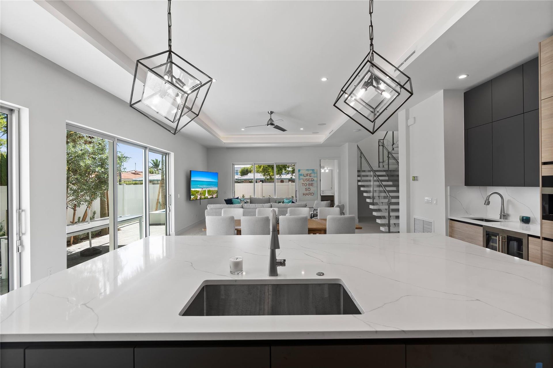 221 Shore Court, Lauderdale By The Sea, FL 33308 A custom designer kitchen with top of the line appliances, huge island, and tons of cabinetry storage. A remarkable luxury townhome rental that redefines upscale living in the heart of Lauderdale By The Sea. This beautifully designed 3,027 sq. ft residence features 4 spacious beds & 4 baths, making it perfect for families or those who love to entertain.The home also offers an outdoor kitchen and BBQ area, along with a private plunge pool that invites relaxation and fun. For boating enthusiasts, a boat slip is also available for rent. Easy access to a plethora of amenities, beach, dining, & entertainment.