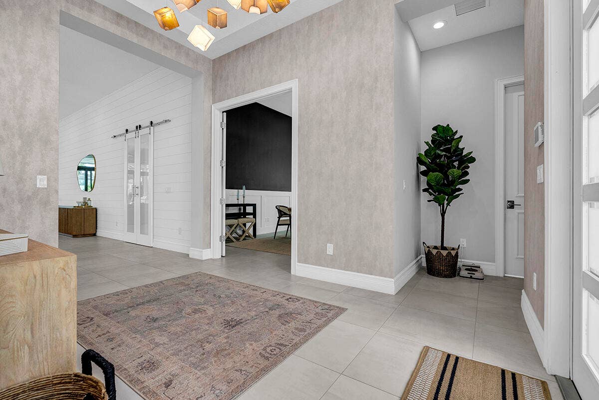9046 CHAUVET Way, Boca Raton, FL 33496 Entryway featuring light-toned tile flooring, textured wall finishes, and a contemporary ceiling light fixture