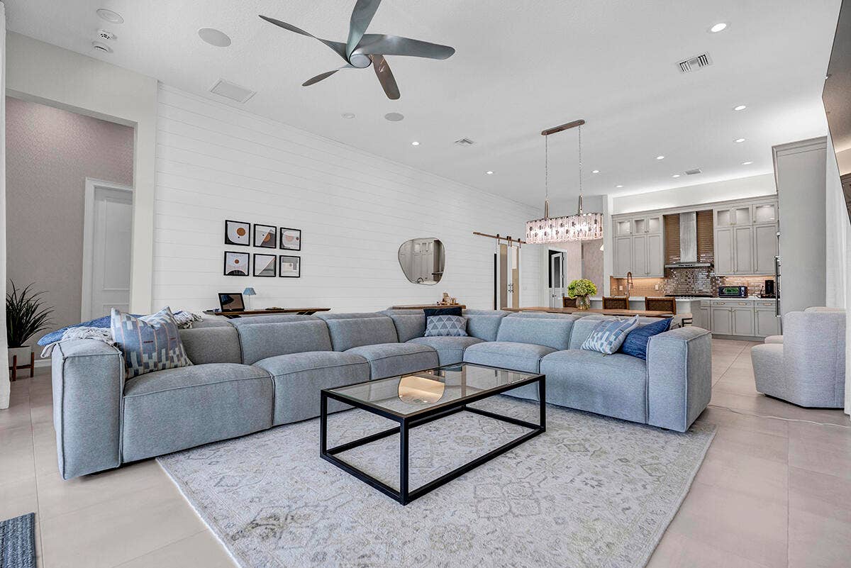 9046 CHAUVET Way, Boca Raton, FL 33496 Spacious open-concept living area featuring high vaulted ceilings, recessed lighting, and a contemporary ceiling fan
