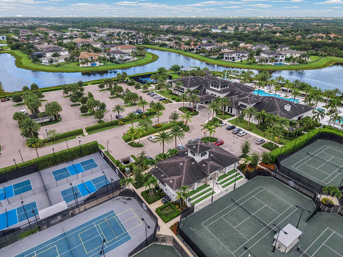 9046 CHAUVET Way, Boca Raton, FL 33496 Aerial perspective showcasing a community clubhouse with multiple pools, surrounded by tennis and pickleball courts