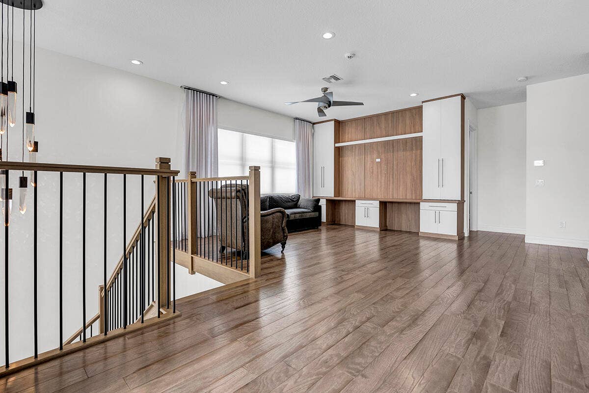 9046 CHAUVET Way, Boca Raton, FL 33496 Hardwood-style flooring throughout, featuring a staircase with wood newel posts and black metal balusters