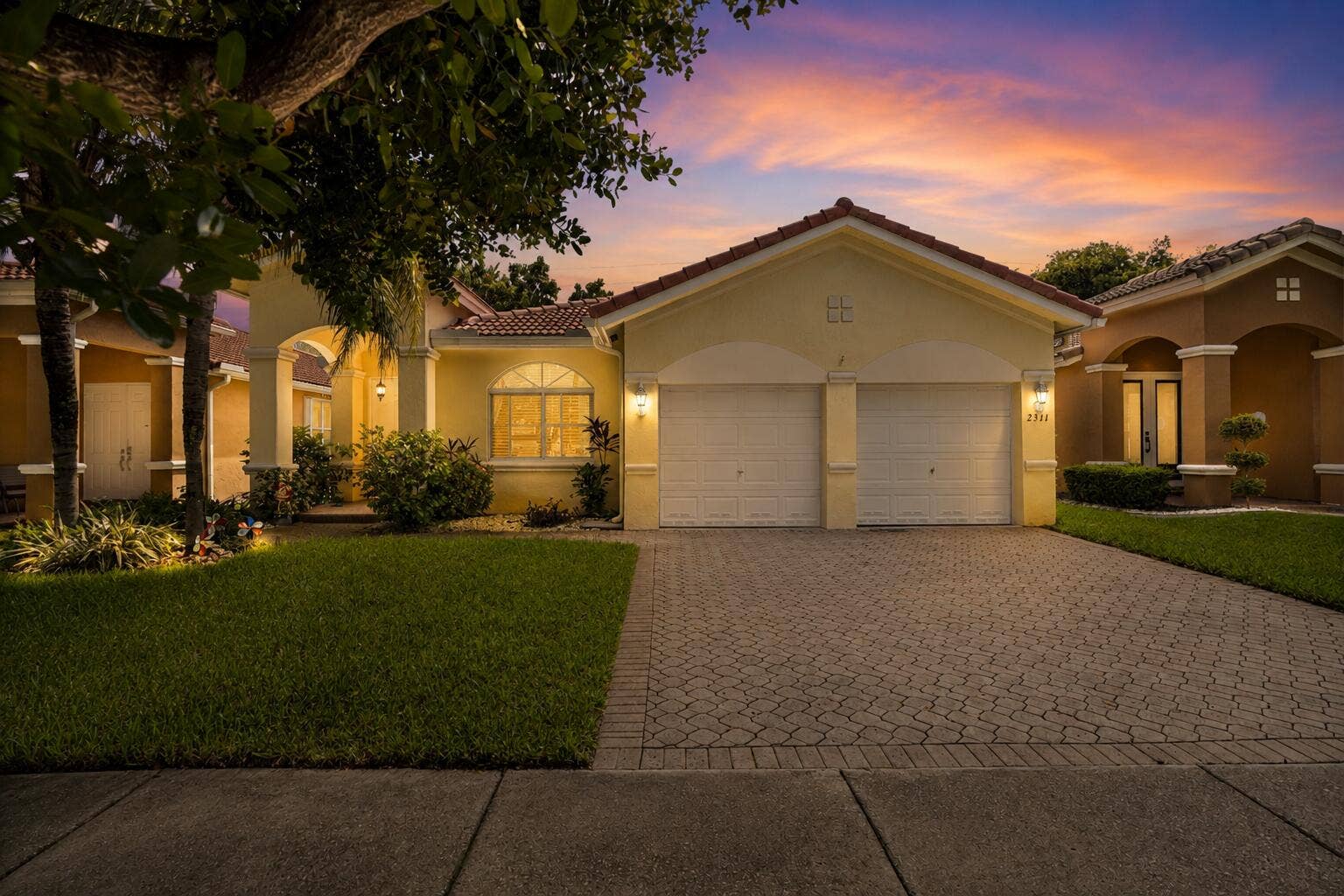 2311 SW 125th Avenue, Miramar, FL 33027 Twilight view. 3-BD, 2-BA home features a spacious floor plan with volume ceilings. The A/C, water heater and appliances including the washer & dryer, refrigerator and dishwasher were replaced 3-5 years ago.