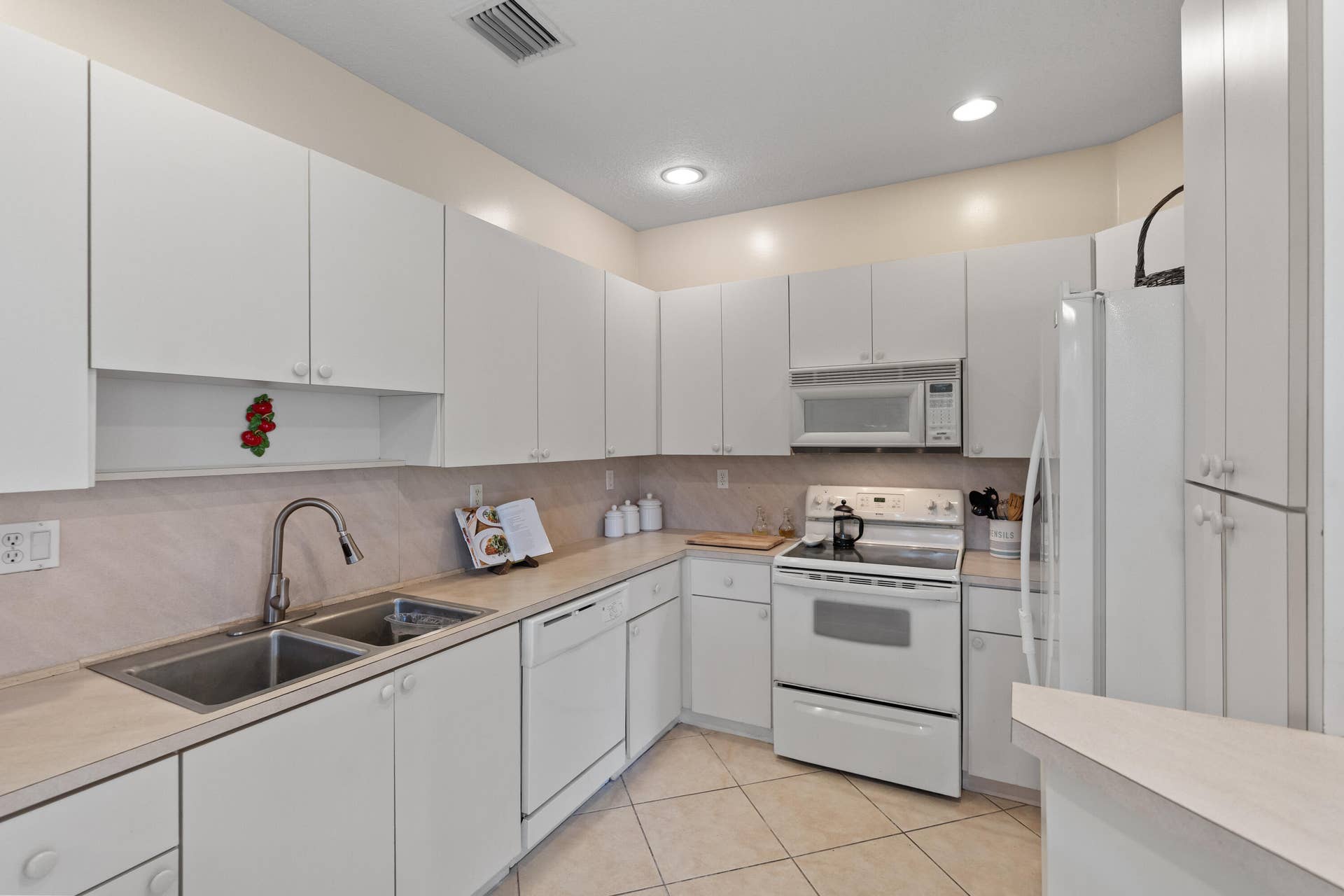 2311 SW 125th Avenue, Miramar, FL 33027 Kitchen featuring white cabinetry, a double basin stainless steel sink, tile flooring, white appliances, and recessed lighting