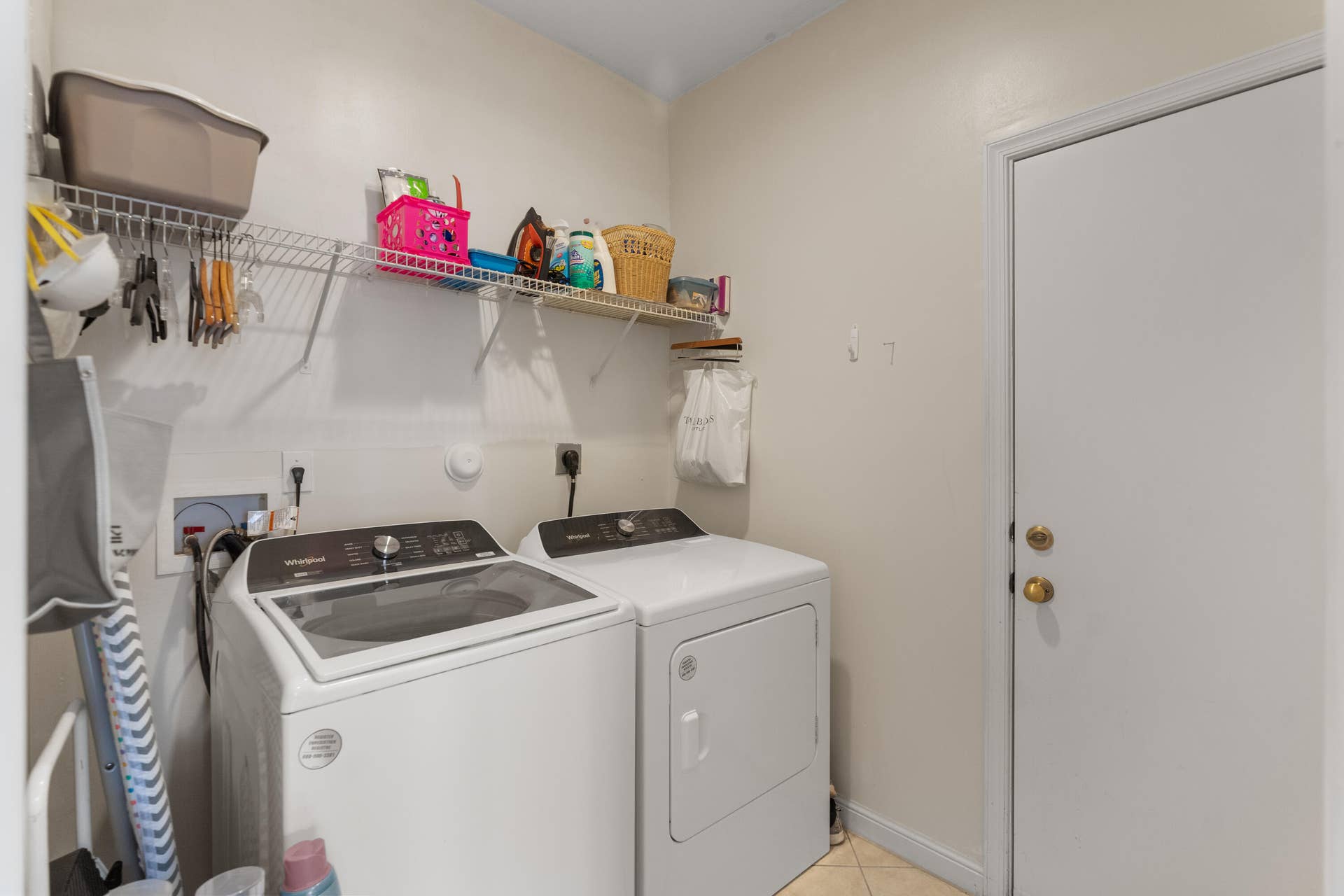 2311 SW 125th Avenue, Miramar, FL 33027 Dedicated laundry area featuring a washer and dryer, complete with overhead wire shelving for storage