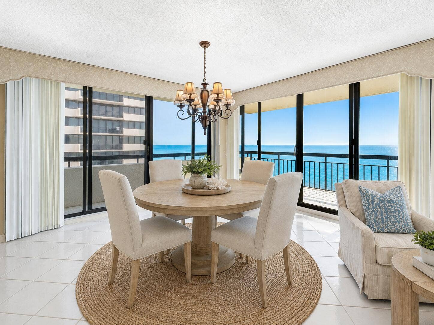 Ocean-facing dining is surrounded by glass, creating an extraordinary backdrop for everyday meals and entertaining. Virtually staged; furnishings and dcor are digitally added and are not included.