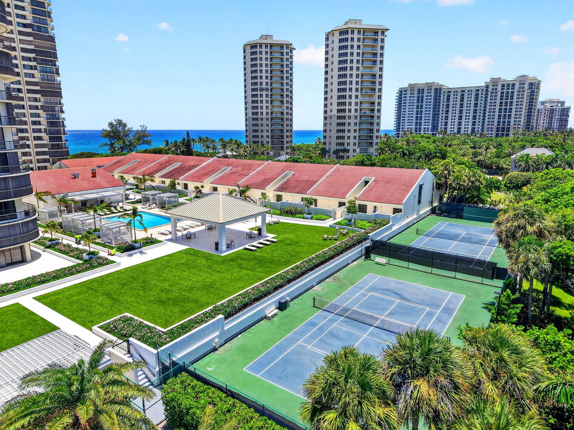 Martinique 2s expansive amenity grounds bring together landscaped lawns, tennis courts, shaded gathering spaces and the resort-style pool in one beautifully designed setting.