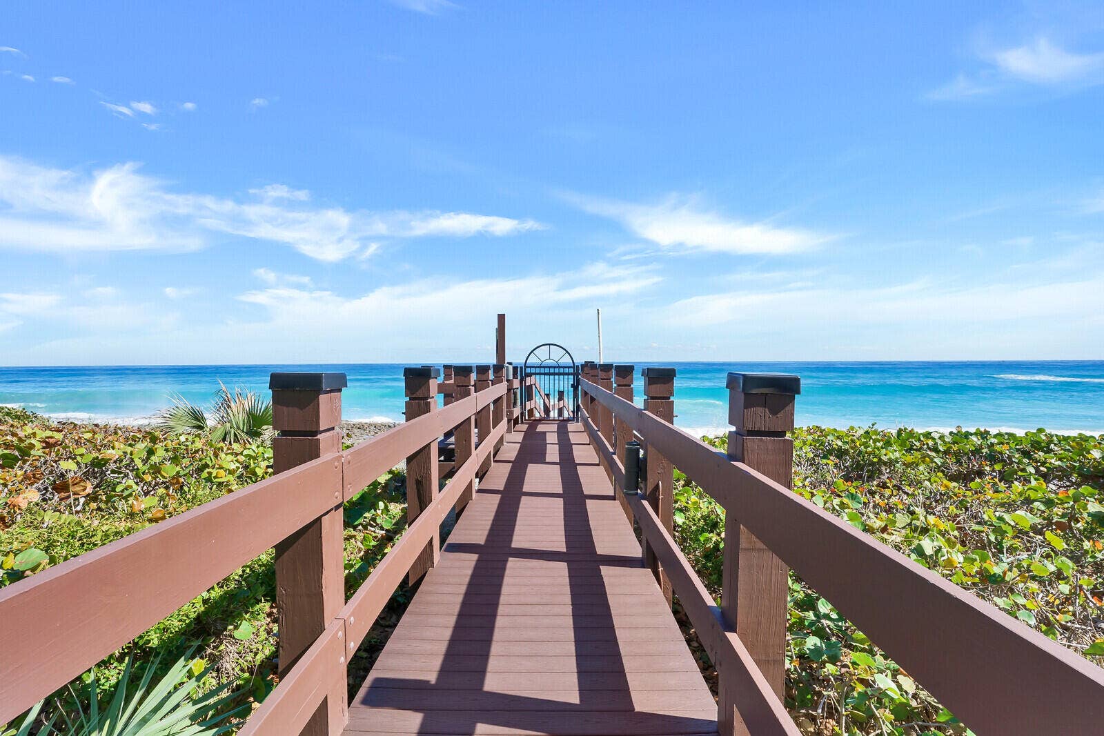 Direct community boardwalk leads through the dunes toward the Atlanticputting Singer Island's beach lifestyle just steps from home.