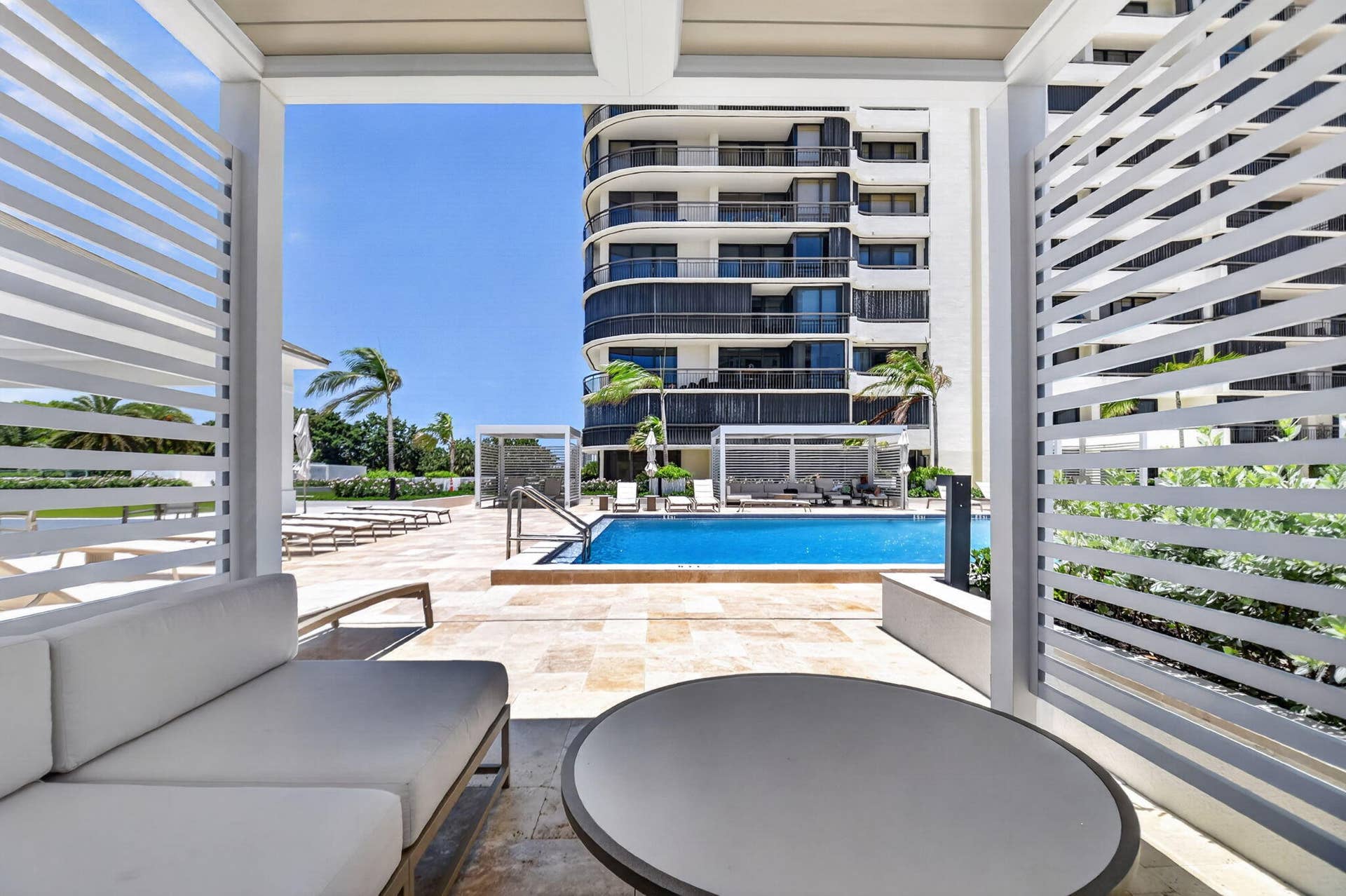Covered poolside lounge areas create comfortable spaces for relaxing, reading or gathering with friends.