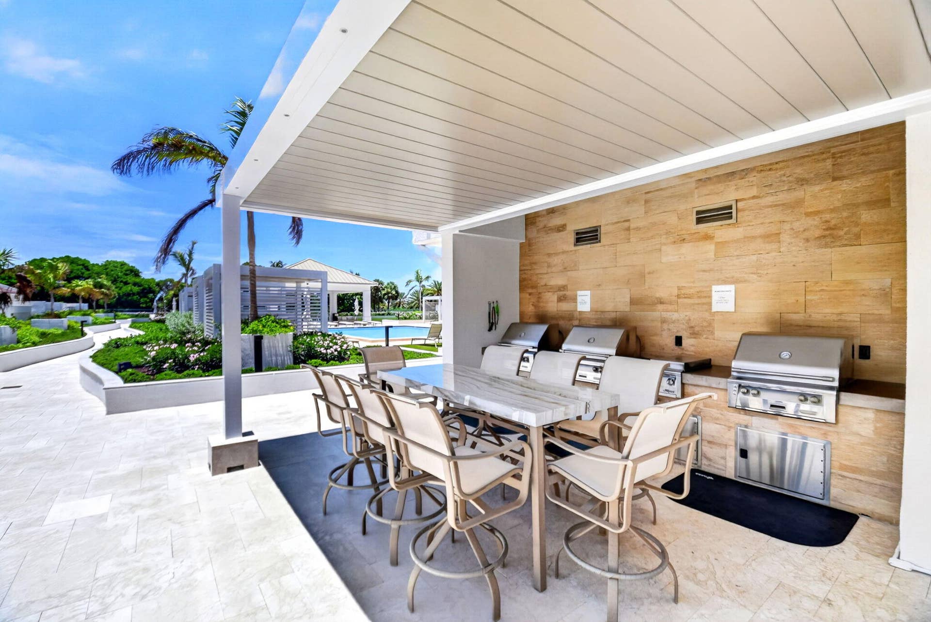 Large grilling and seating area located on the pool deck for residents to enjoy