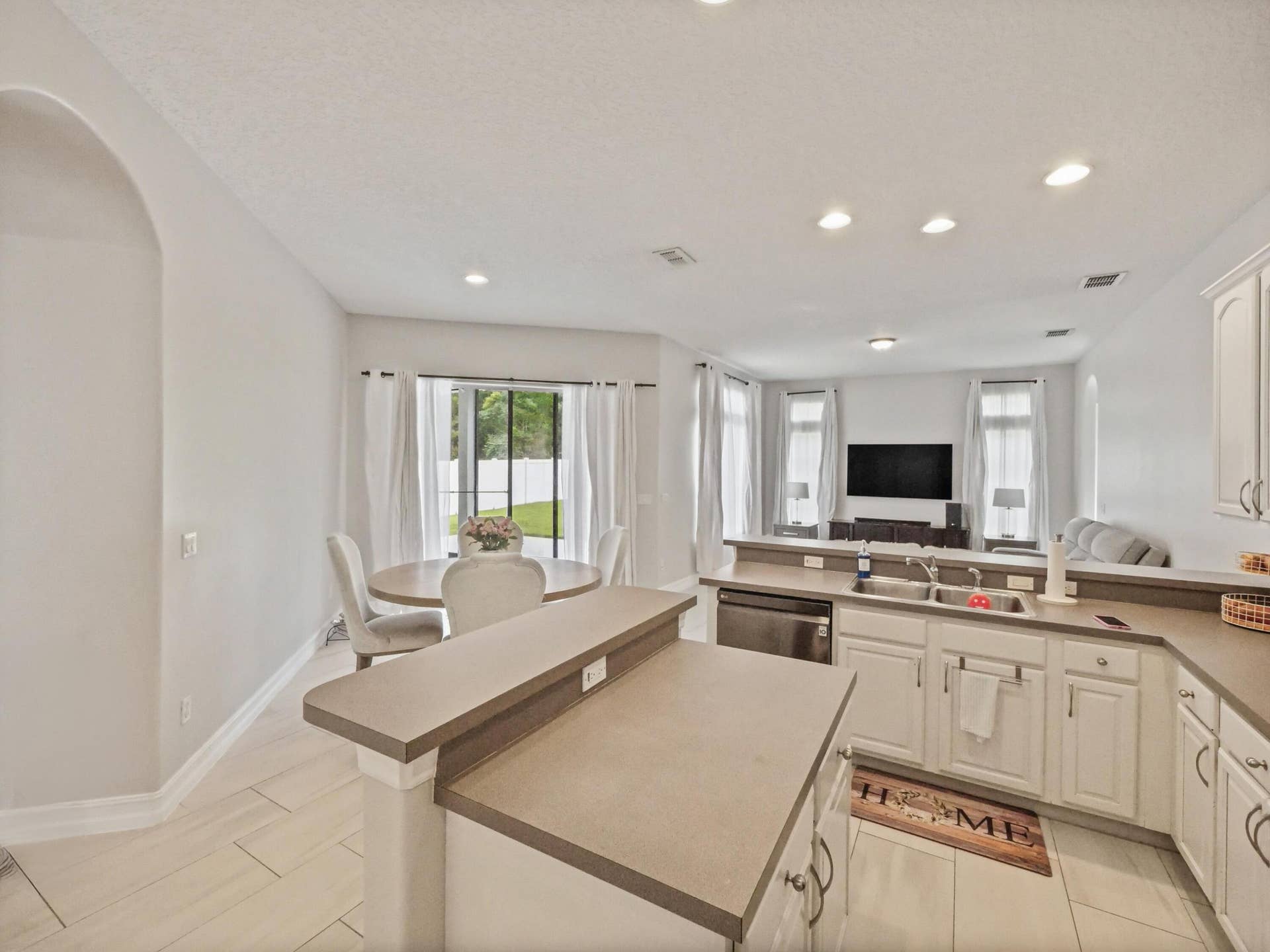 16437 TUDOR GROVE Drive, Orlando, FL 32828 Kitchen featuring a double basin sink, white cabinetry, integrated dishwasher, and recessed lighting