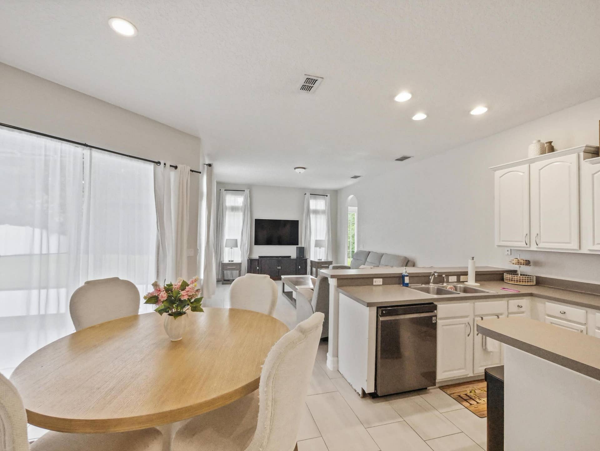 16437 TUDOR GROVE Drive, Orlando, FL 32828 White cabinetry with stainless steel appliances, recessed lighting, and tile flooring