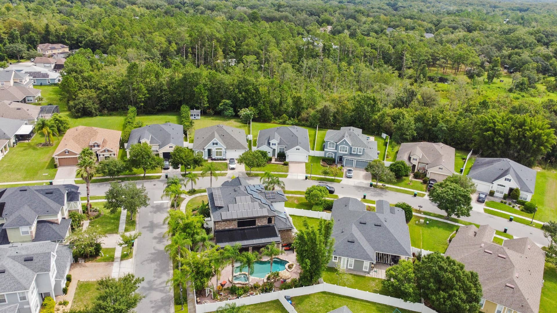 16437 TUDOR GROVE Drive, Orlando, FL 32828 Residential neighborhood with varied architectural styles and mature landscaping