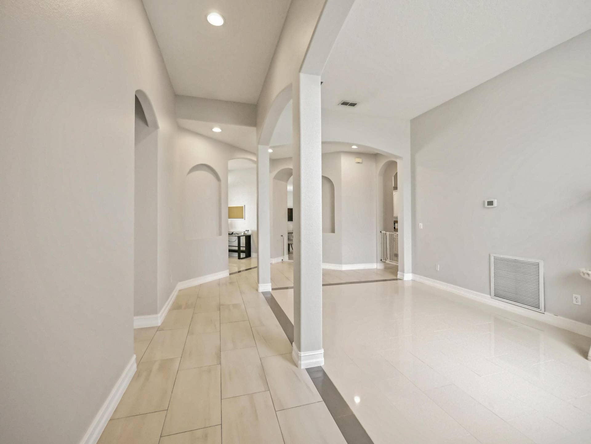 16437 TUDOR GROVE Drive, Orlando, FL 32828 Arched doorways and wall cutouts with recessed lighting, tile flooring, and vaulted ceilings