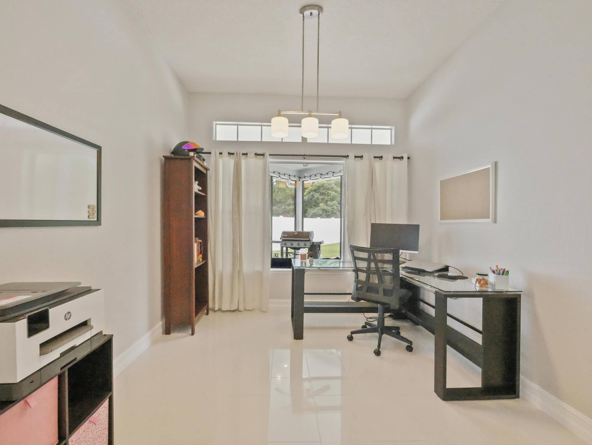 16437 TUDOR GROVE Drive, Orlando, FL 32828 Expansive room featuring high ceilings, light-toned tile flooring, and a large window with transom accent