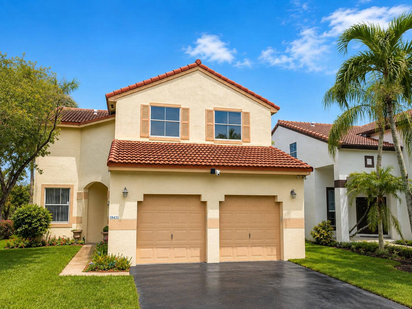 18431 NW 18TH Street, Pembroke Pines, FL 33029 Stucco exterior with a tile roof, two-car garage, and decorative window shutters