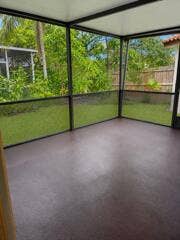 18431 NW 18TH Street, Pembroke Pines, FL 33029 Screened enclosure with a solid roof, concrete flooring, and surrounding foliage