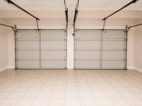 18431 NW 18TH Street, Pembroke Pines, FL 33029 Two-car garage featuring a tiled floor and dual overhead doors with automatic openers