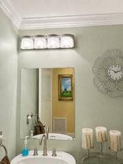 18431 NW 18TH Street, Pembroke Pines, FL 33029 Crown molding, wall-mounted vanity lighting, framed mirror, and a basin sink with a brushed nickel faucet