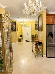 18431 NW 18TH Street, Pembroke Pines, FL 33029 Recessed lighting and a grand chandelier illuminate the entry hall