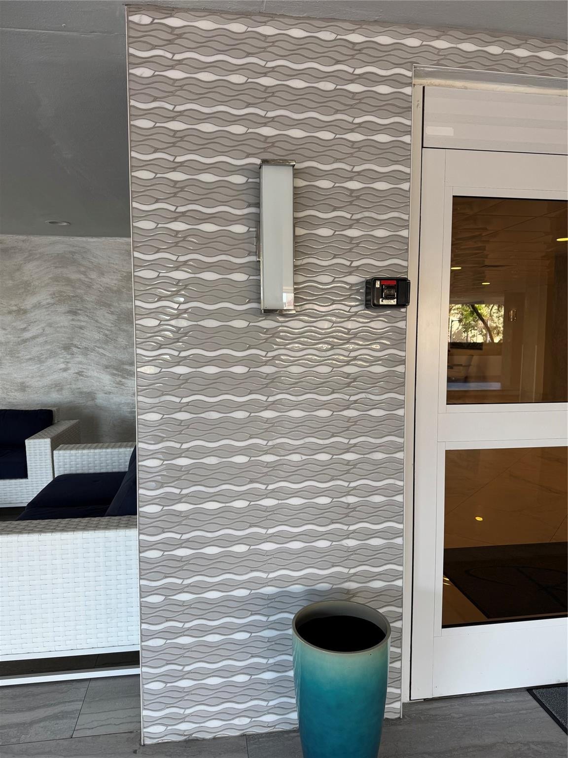 3800 GALT OCEAN Drive, #1508, Fort Lauderdale, Fort Lauderdale, FL 33308 Textured tile wall detailing a wave pattern, integrated wall sconce, and a secure entry system