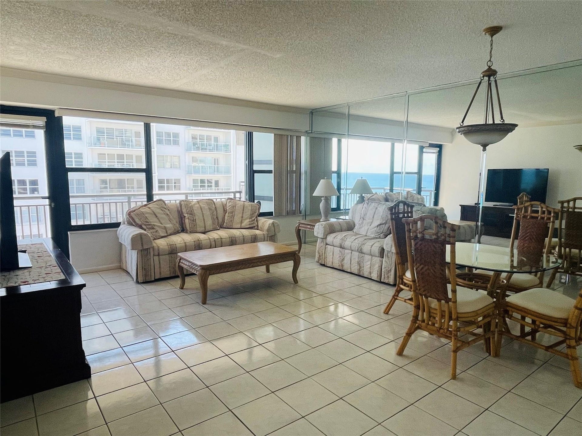 3800 GALT OCEAN Drive, #1508, Fort Lauderdale, Fort Lauderdale, FL 33308 Tiled flooring throughout, wall of windows, glass panel balcony door, integrated wall mirror, and a ceiling-mounted light fixture