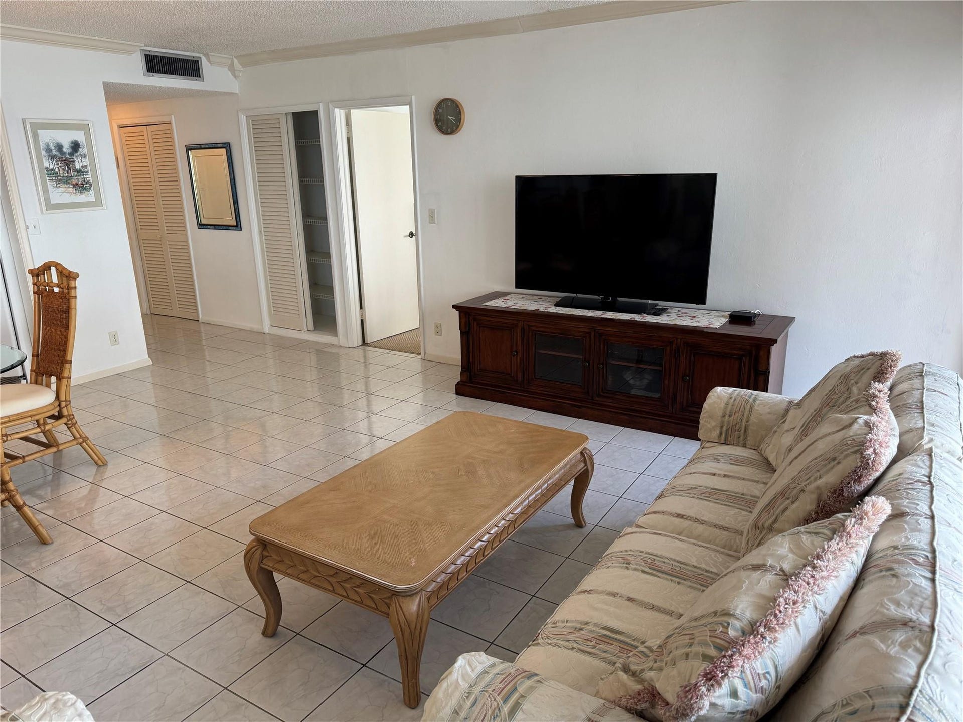 3800 GALT OCEAN Drive, #1508, Fort Lauderdale, Fort Lauderdale, FL 33308 White tile flooring throughout, white walls, and a built-in wood-finish media console