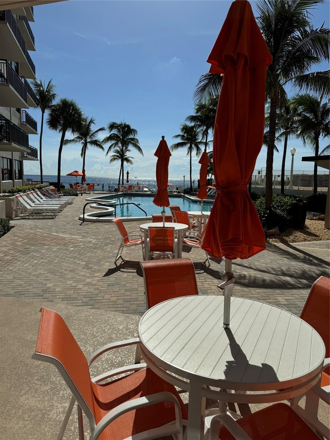 3800 GALT OCEAN Drive, #1508, Fort Lauderdale, Fort Lauderdale, FL 33308 Outdoor pool area featuring a paver patio, a swimming pool with an integrated spa, and palm trees