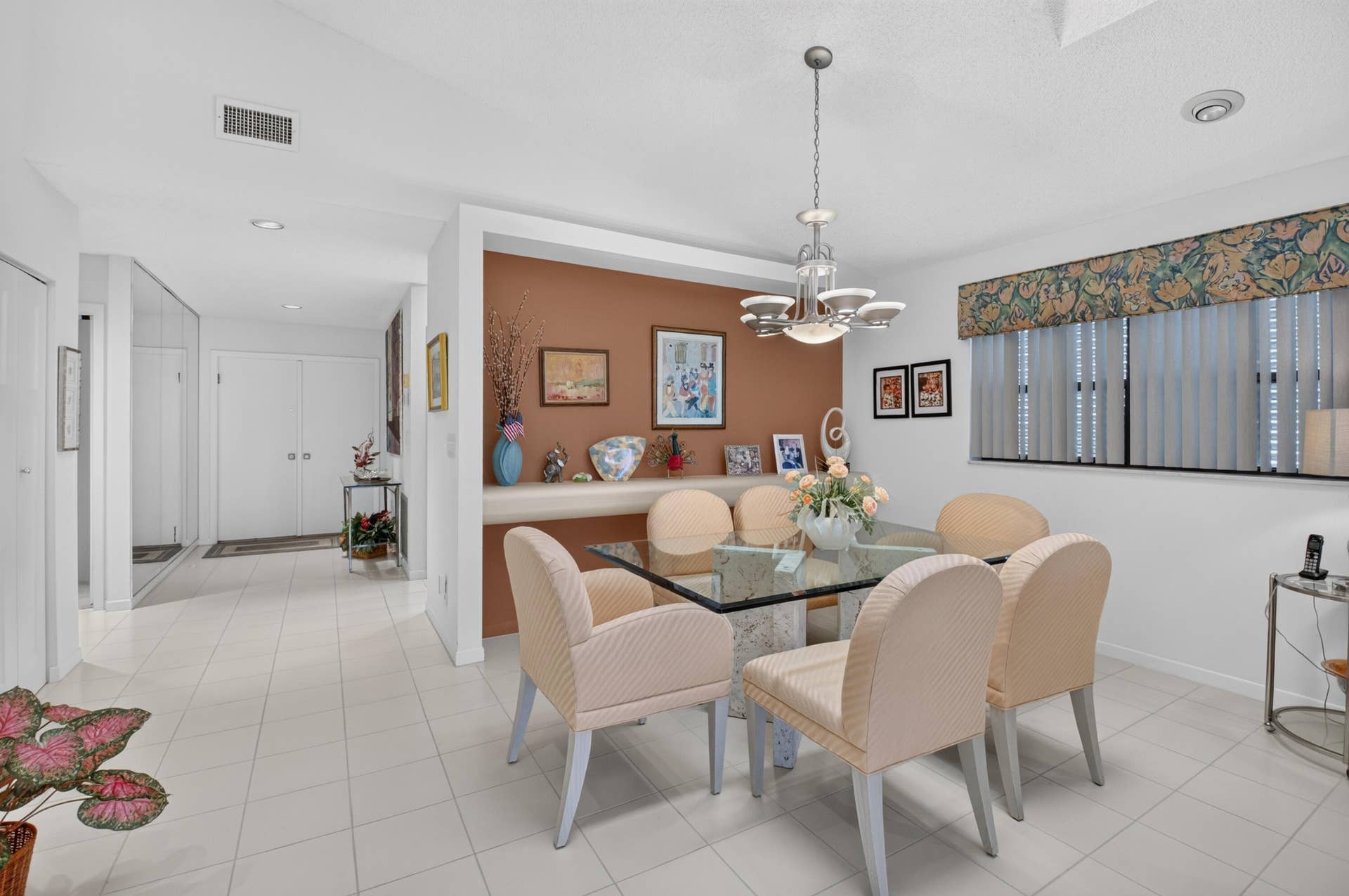 20065 Waters Edge Drive, #101, Boca Raton, FL 33434 Recessed lighting throughout, tile flooring, built-in shelving, window with vertical blinds, and a chandelier lighting fixture