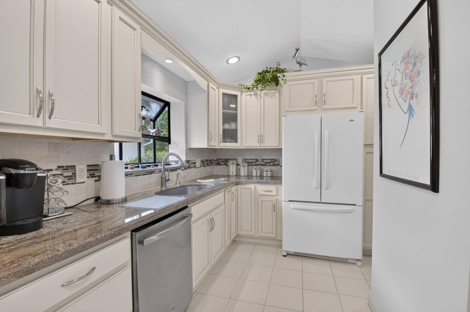 20065 Waters Edge Drive, #101, Boca Raton, FL 33434 Kitchen featuring cream cabinetry, stainless steel dishwasher, undermount sink, recessed lighting, and tile flooring