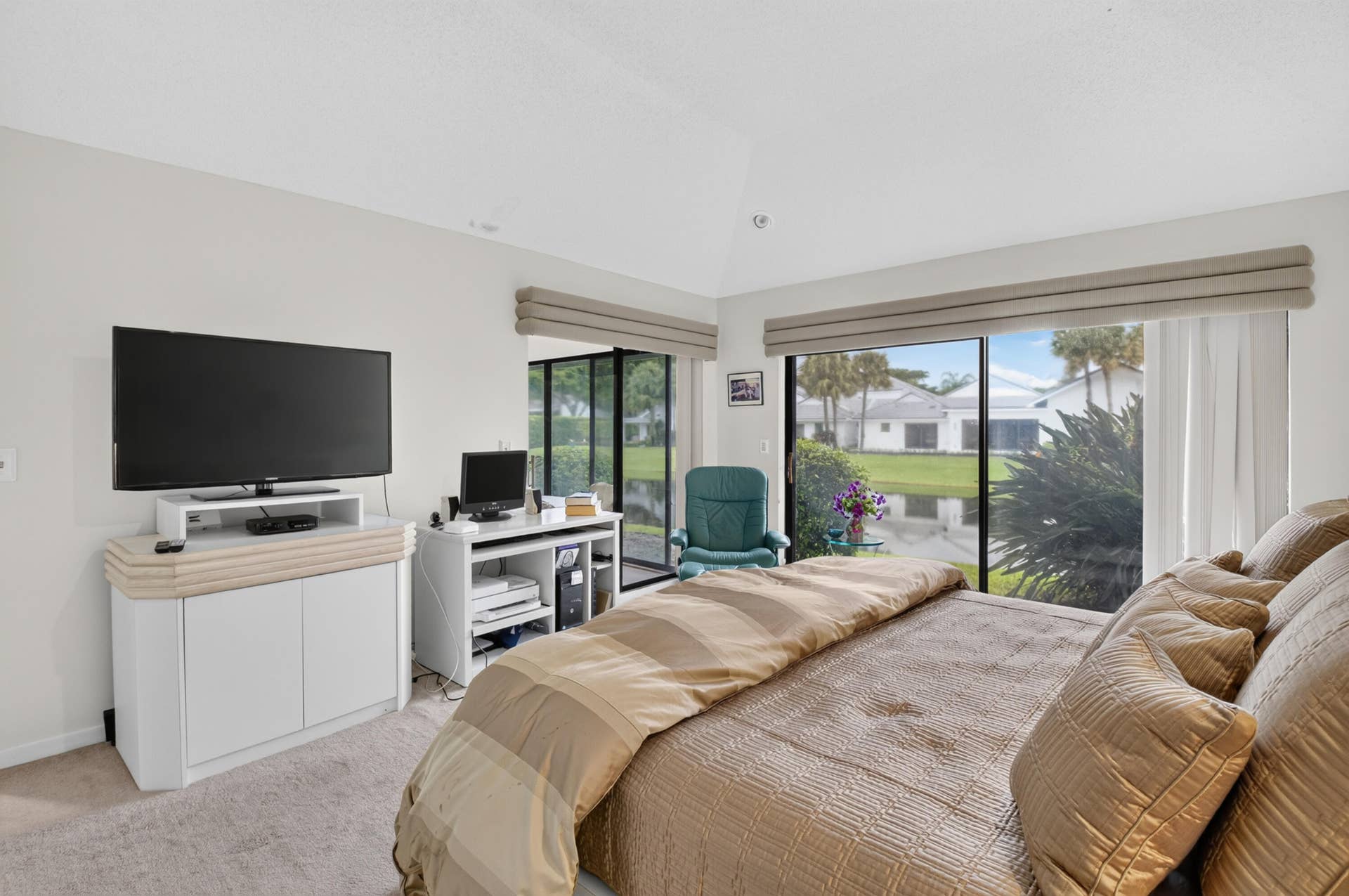 20065 Waters Edge Drive, #101, Boca Raton, FL 33434 Recessed lighting, vaulted ceiling, sliding glass doors, window treatments, and light-colored carpeting