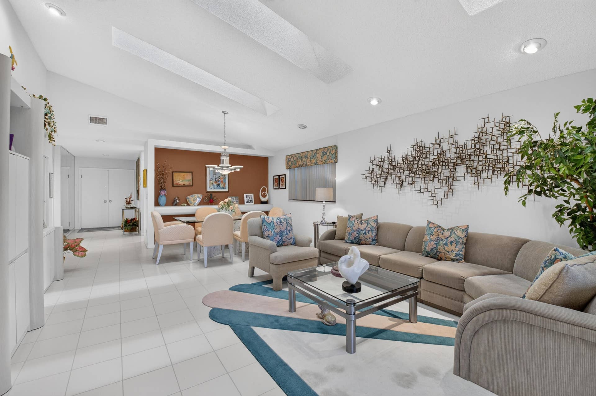 20065 Waters Edge Drive, #101, Boca Raton, FL 33434 Vaulted ceilings with recessed lighting, tile flooring, built-in cabinetry, and a dining area with a chandelier
