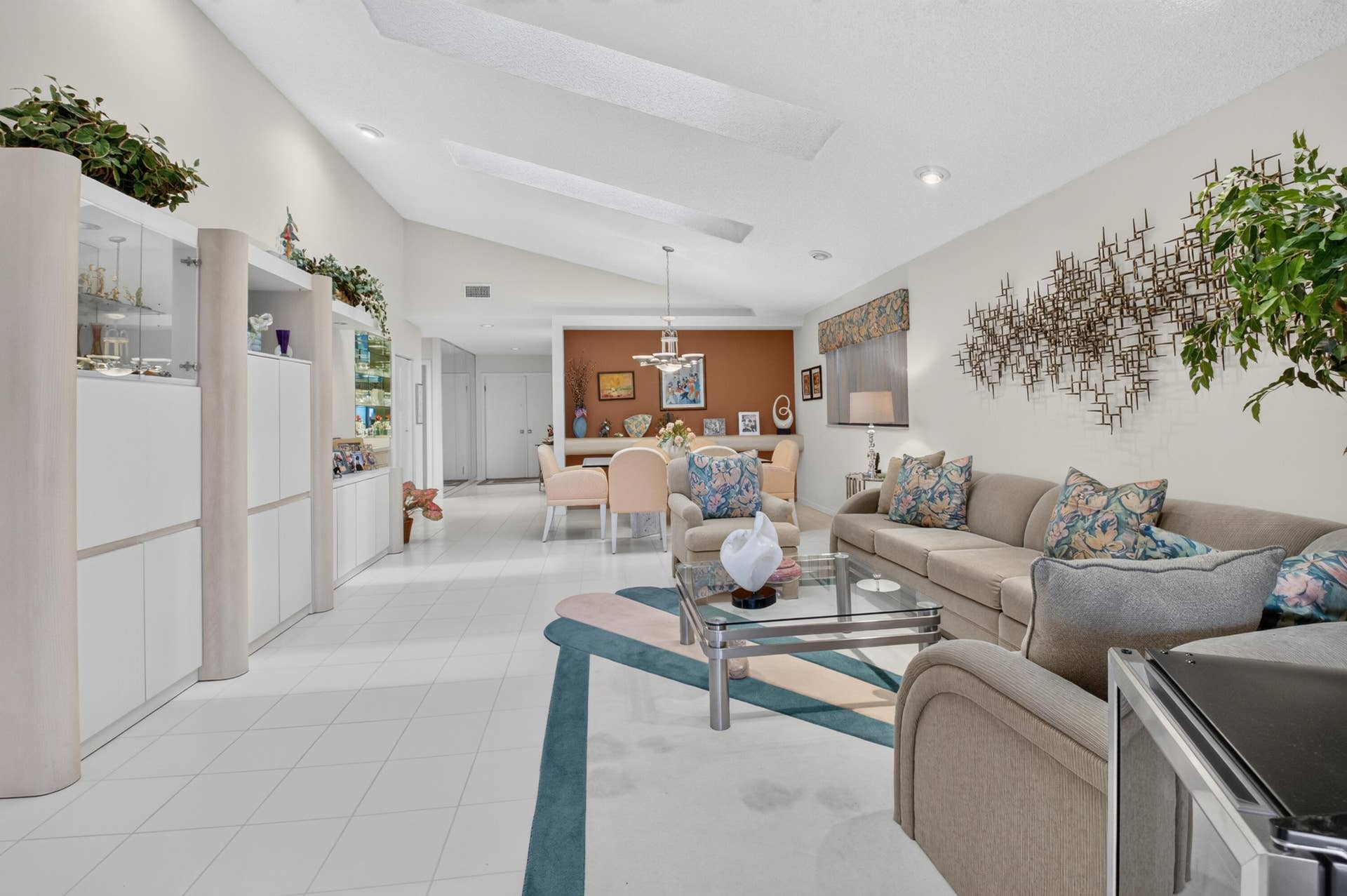 20065 Waters Edge Drive, #101, Boca Raton, FL 33434 Vaulted ceilings with skylights, extensive built-in cabinetry, tile flooring, recessed lighting, and a defined dining area