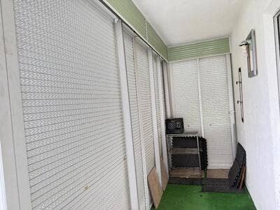 145 Dorchester G, West Palm Beach, FL 33417 The screen porch has partial, roll down hurricane shutters.