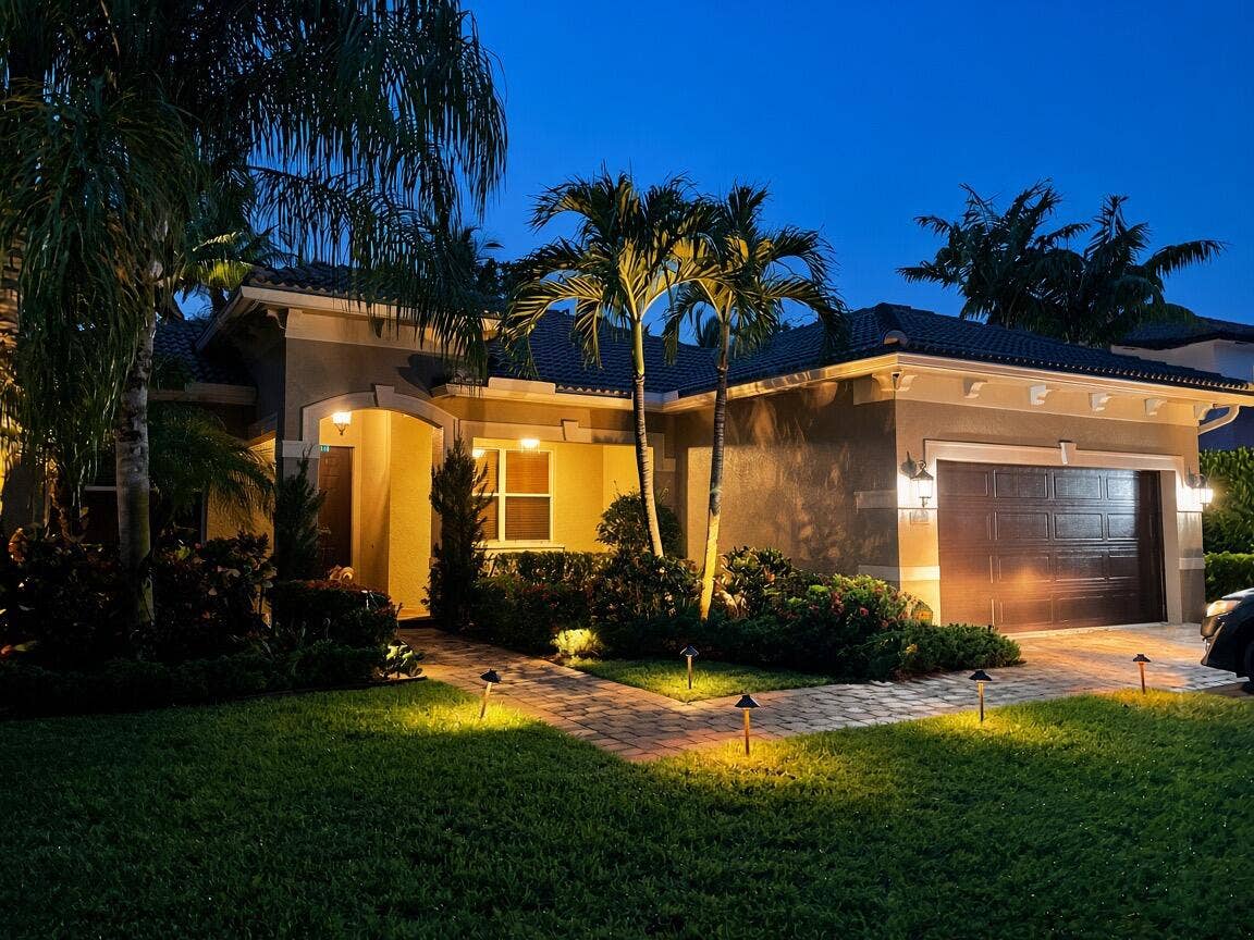 Mediterranean-style exterior with a tile roof, stucco finish, and an integrated garage