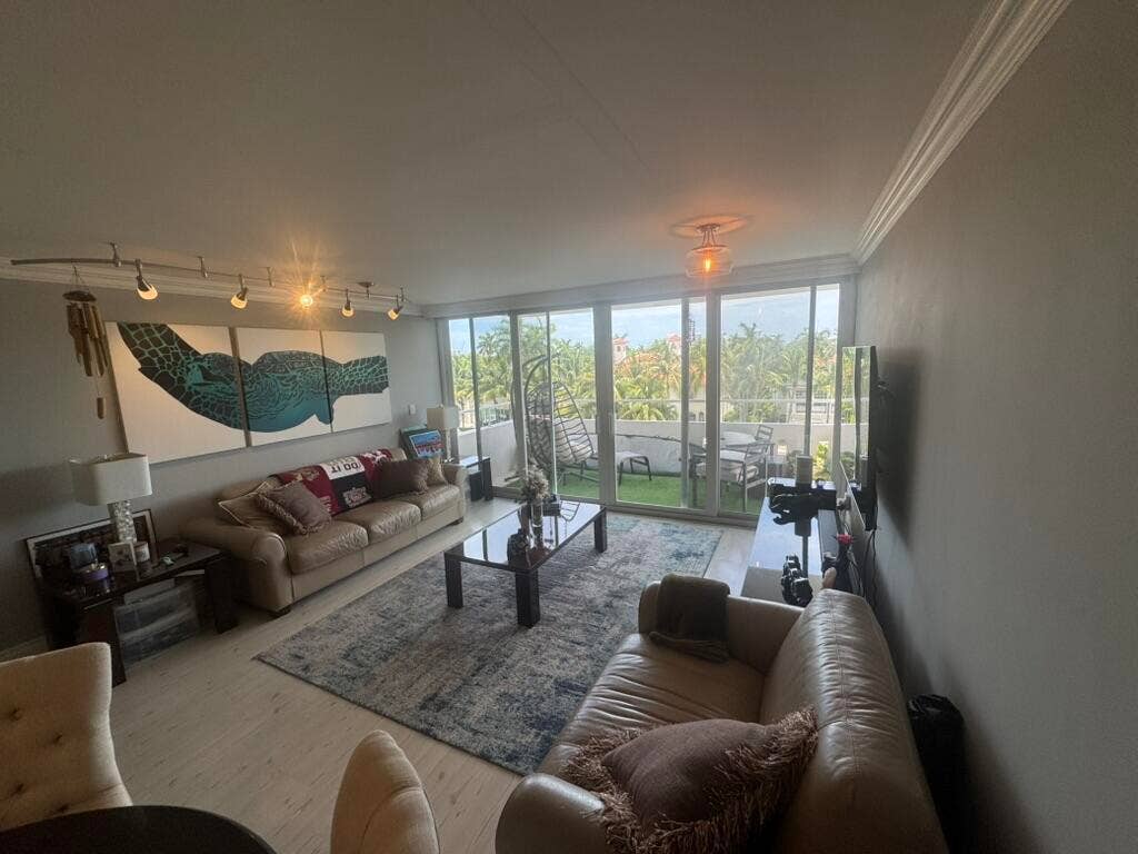 180 Isle Of Venice Drive, #433, Fort Lauderdale, FL 33301 Light wood-finish flooring, full-height glass sliders, track lighting, and crown molding