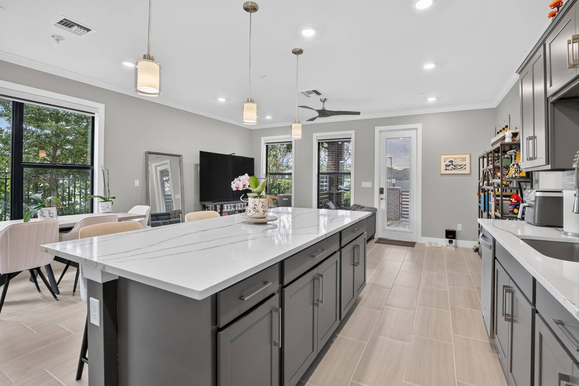 765 NW 84TH Terrace, Plantation, FL 33324 Kitchen featuring a large island with a light-toned countertop, gray cabinetry, recessed lighting, and tile flooring