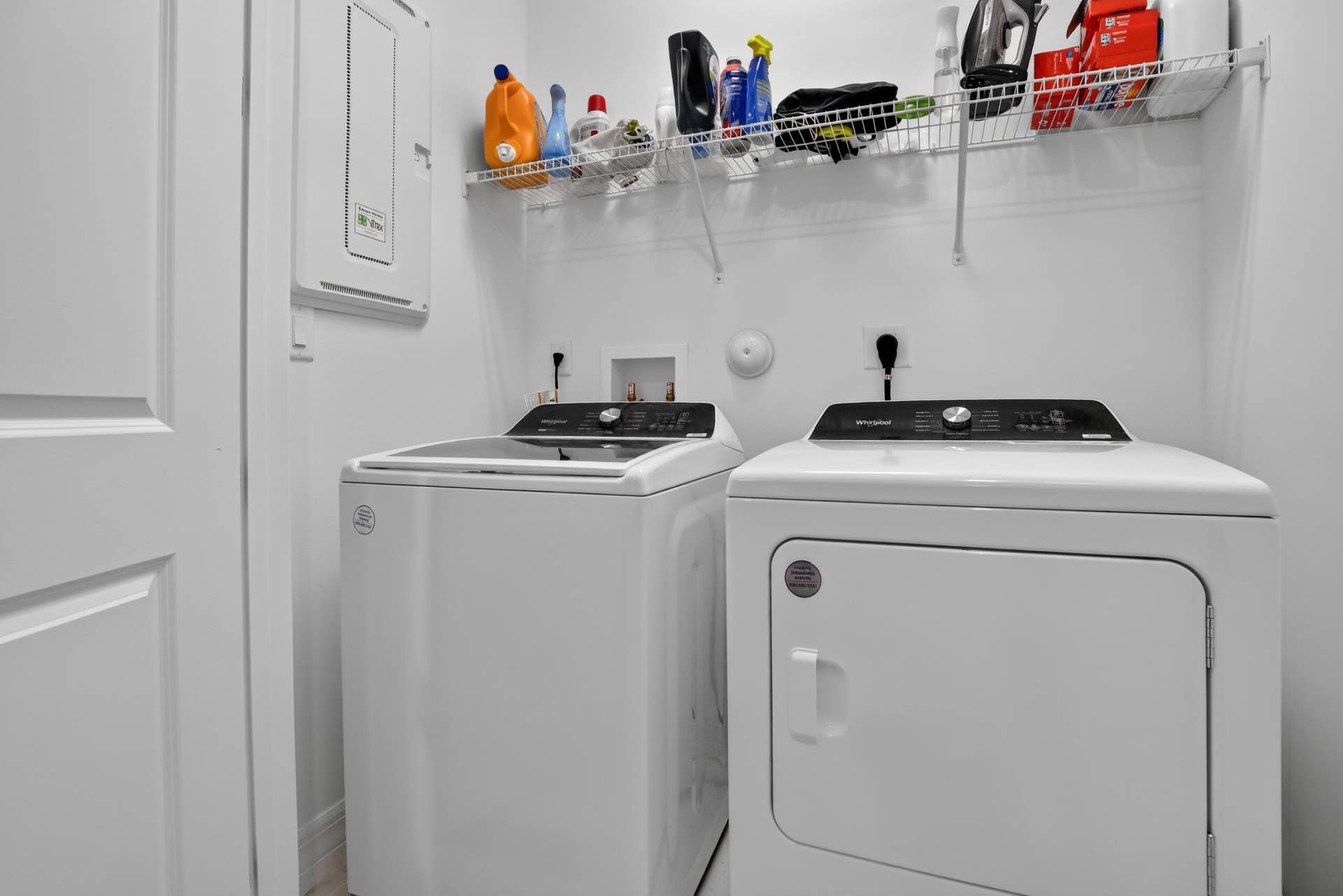 765 NW 84TH Terrace, Plantation, FL 33324 Dedicated laundry room featuring a top-load washer and electric dryer with digital controls, white finish cabinetry, overhead storage shelving, and utility sink with chrome fixtures