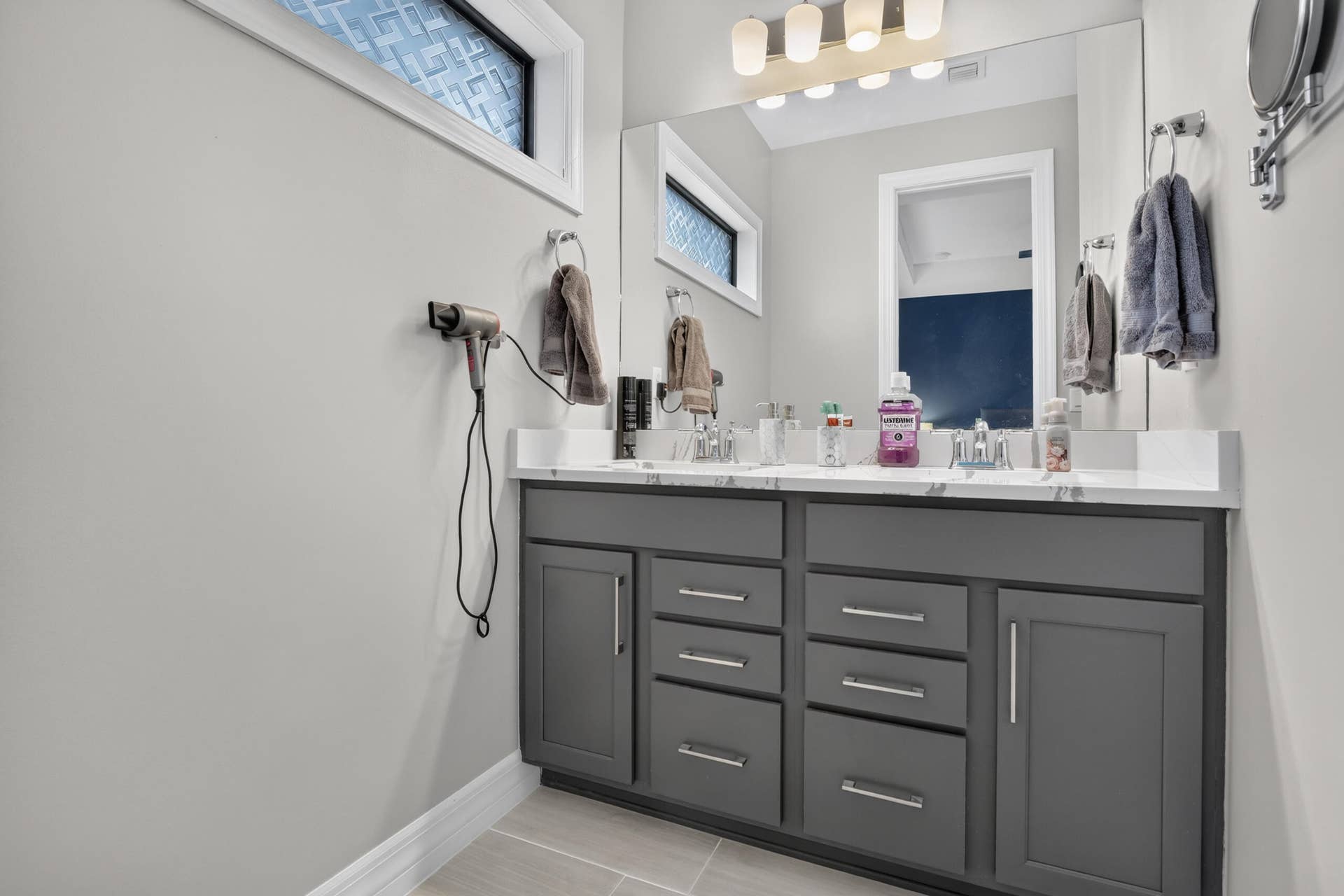 765 NW 84TH Terrace, Plantation, FL 33324 Dual vanity with gray cabinetry and brushed nickel hardware, white countertop, and individual sink basins