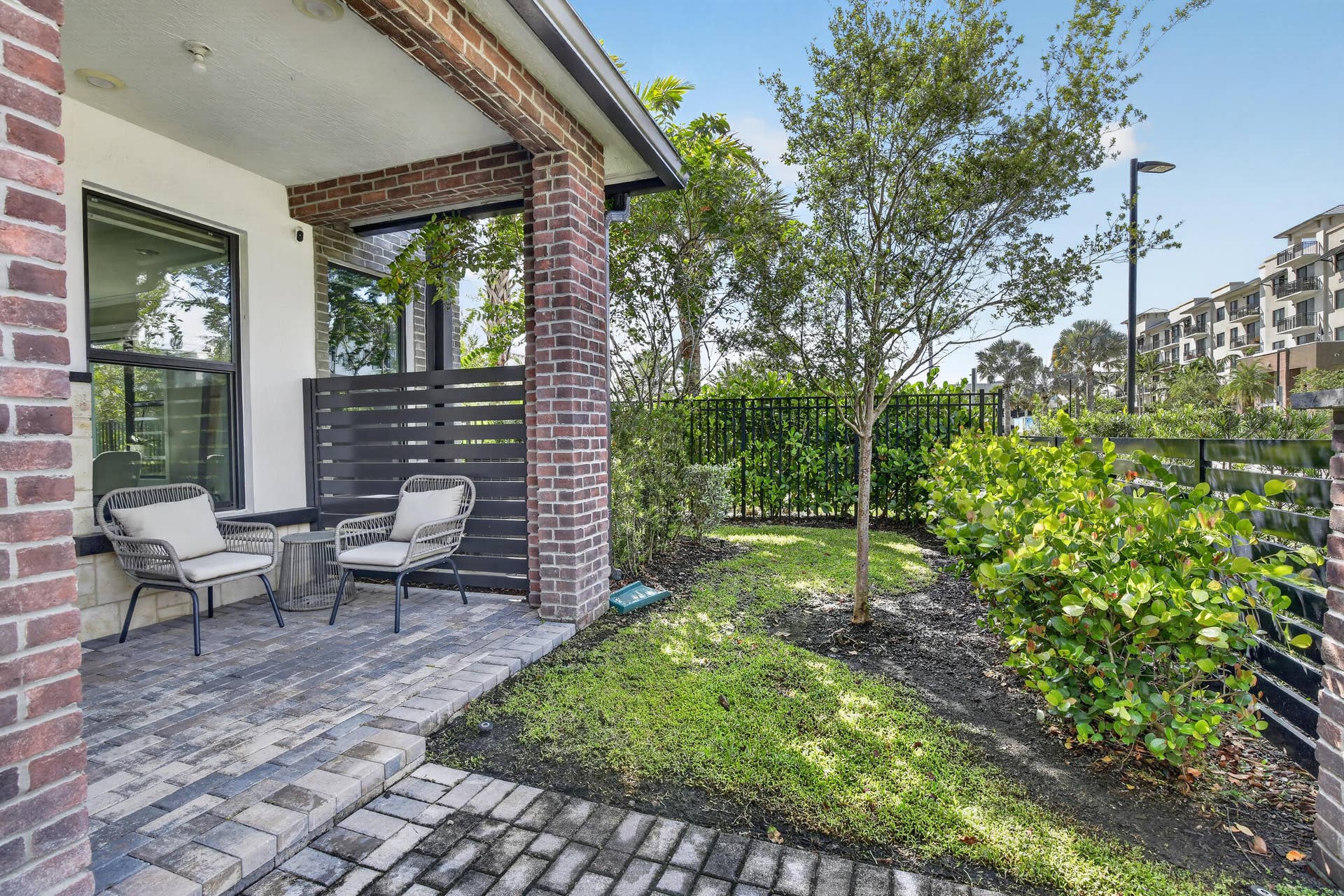 765 NW 84TH Terrace, Plantation, FL 33324 Brick exterior featuring a paver patio and a privacy screen