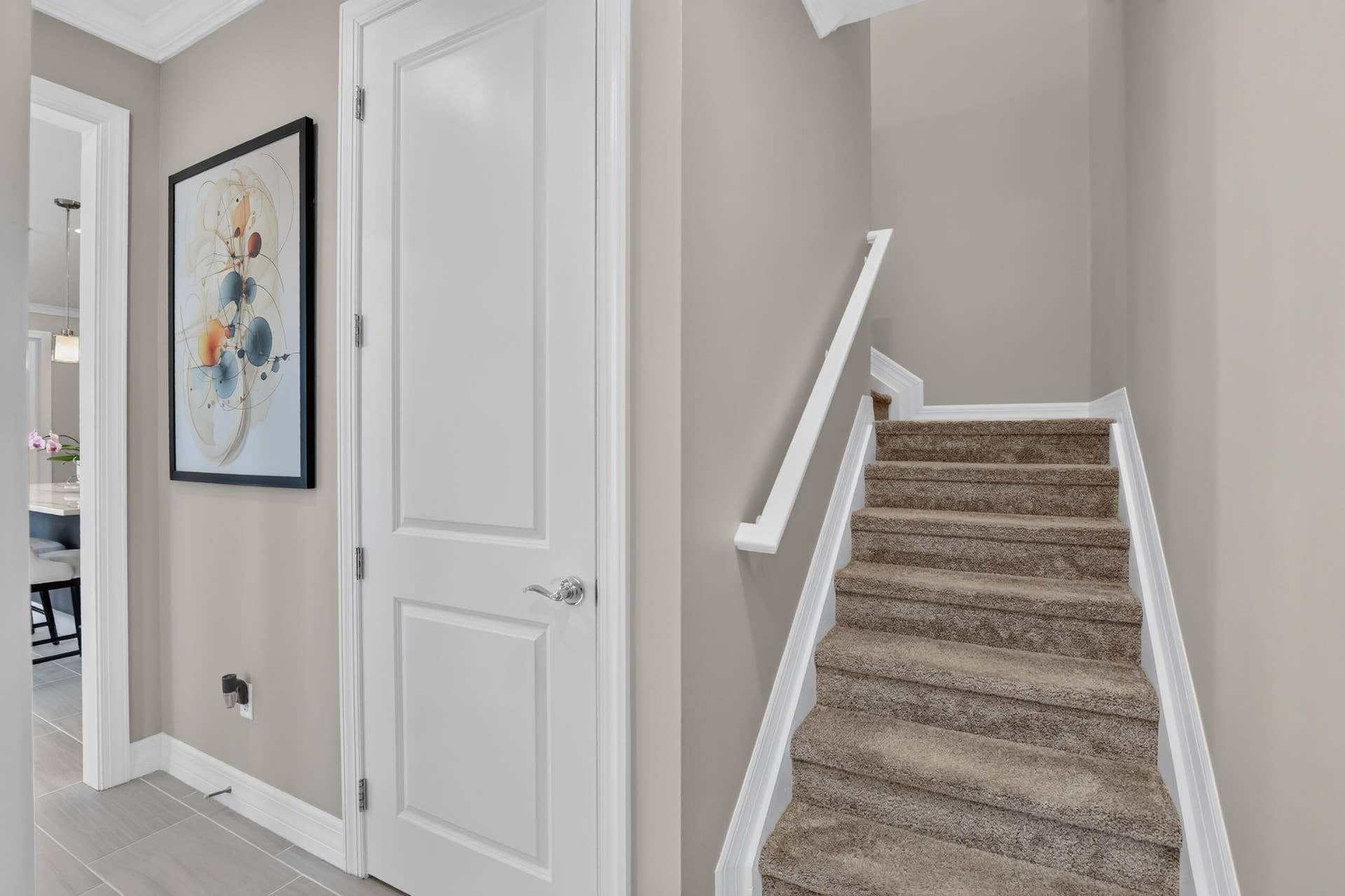 765 NW 84TH Terrace, Plantation, FL 33324 Carpeted staircase with white handrail and risers, complemented by light gray wall tones and white paneled doors