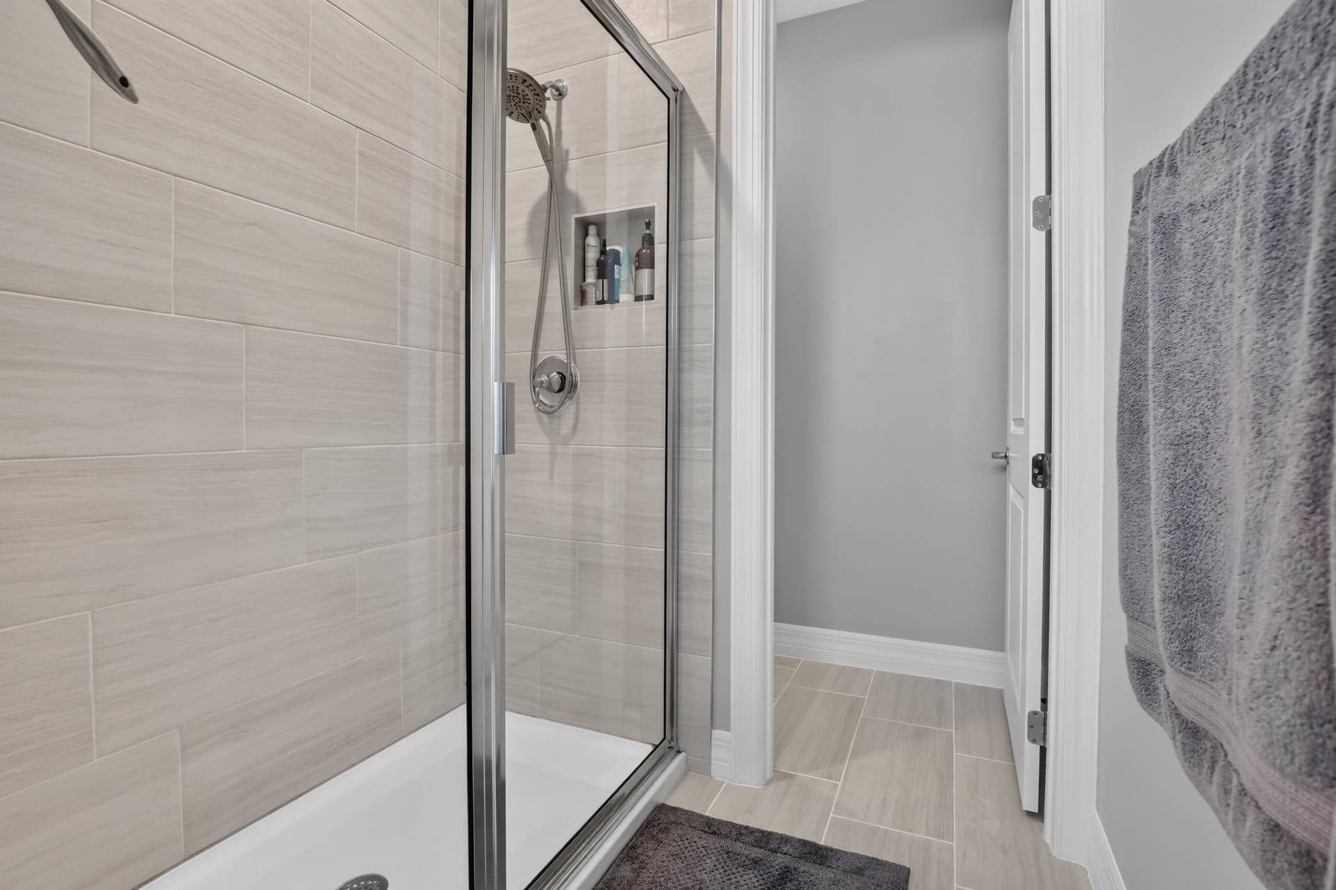 765 NW 84TH Terrace, Plantation, FL 33324 Walk-in shower with clear glass enclosure, a built-in shower niche, and a brushed nickel shower head