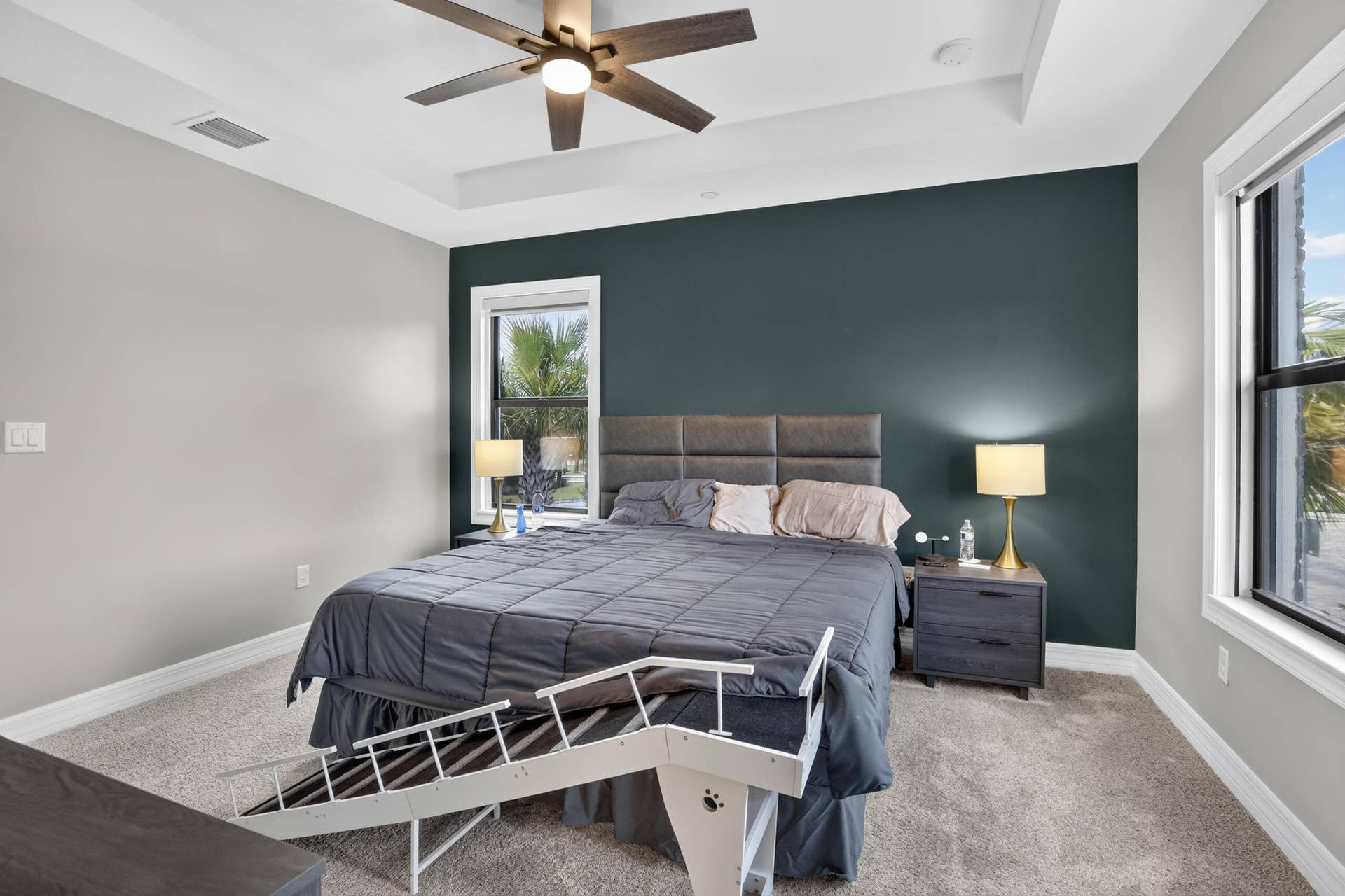 765 NW 84TH Terrace, Plantation, FL 33324 Tray ceiling with a ceiling fan, accent wall, and double windows with white trim