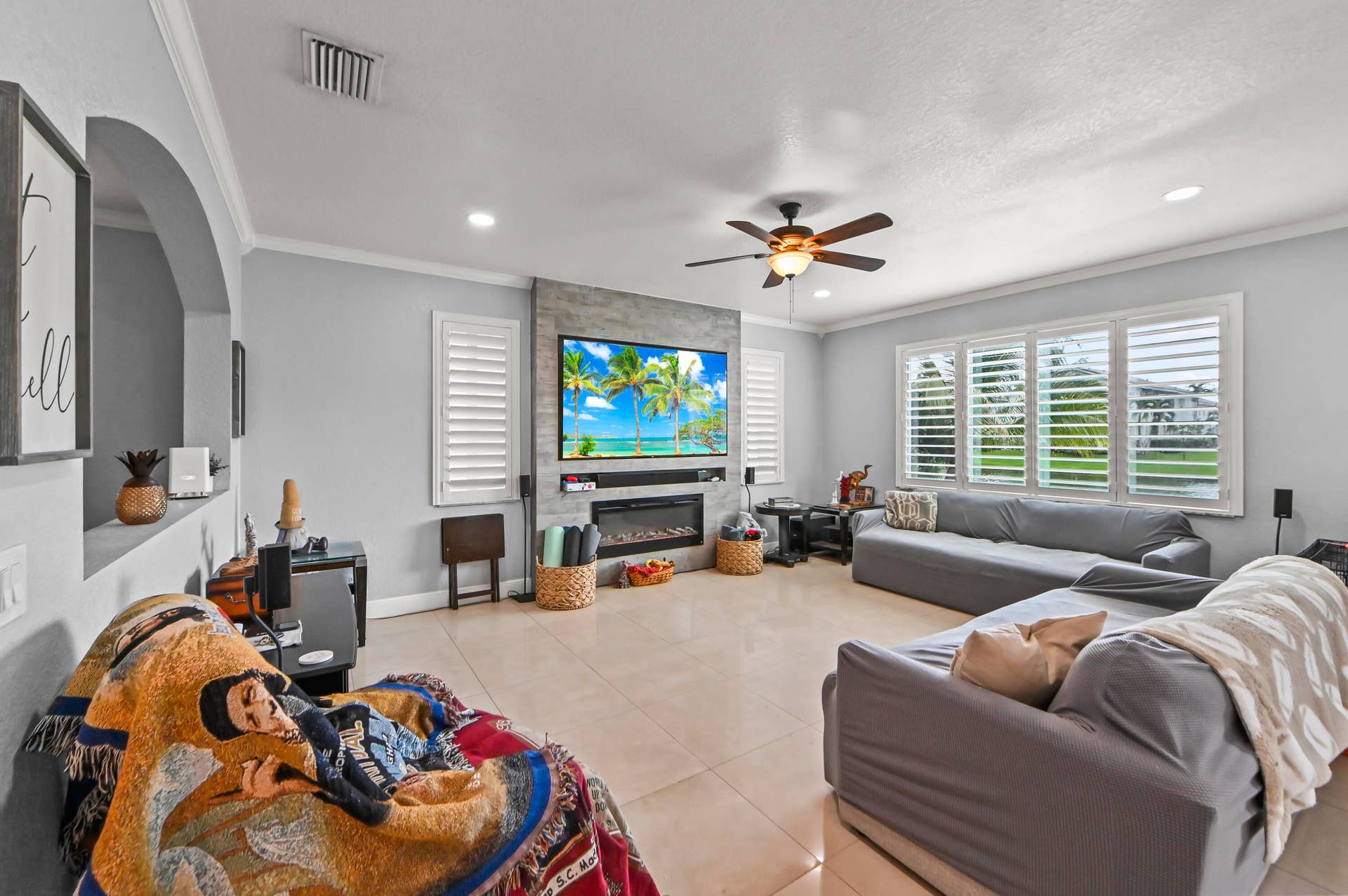 Recessed lighting, crown molding, and a ceiling fan with integrated lighting