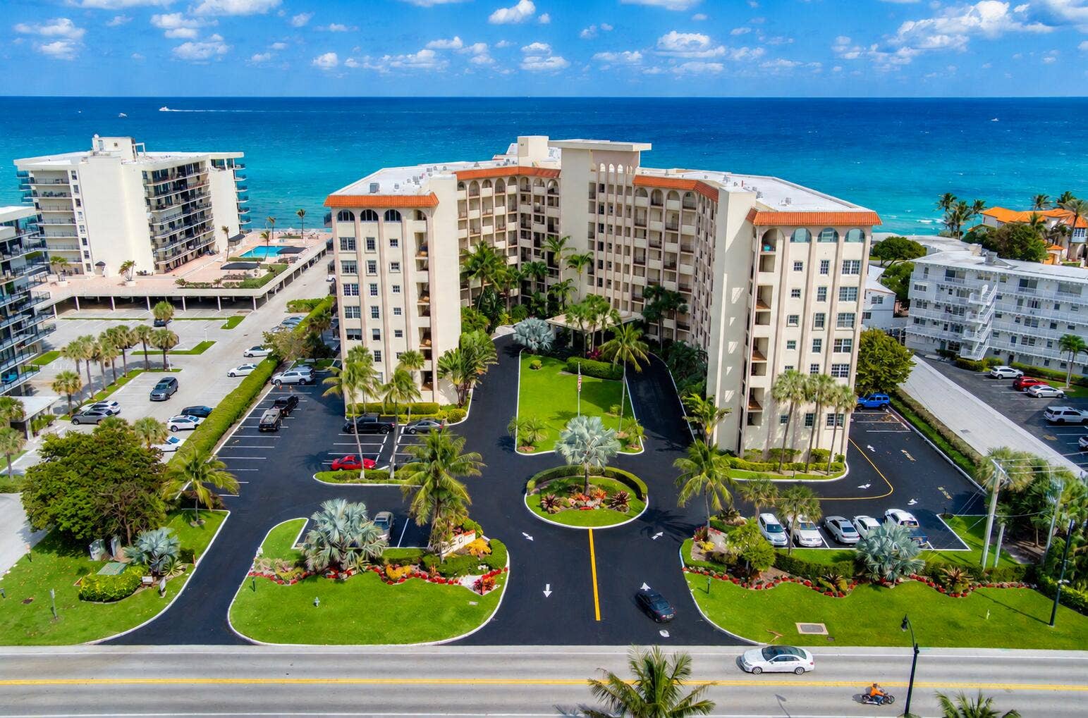 3475 S OCEAN Boulevard, #2050, Palm Beach, FL 33480 Coastal multi-story building featuring multiple balconies, a circular driveway, and landscaped grounds