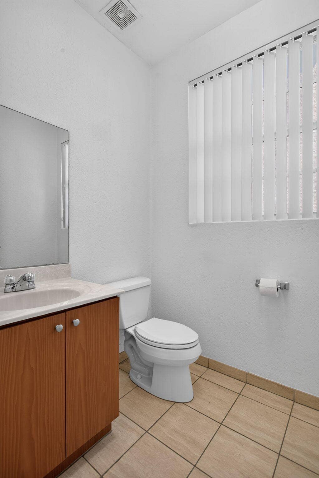2725 NE 8TH Avenue, #112, Wilton Manors, FL 33334 Wood-finish vanity with an integrated sink and chrome faucet