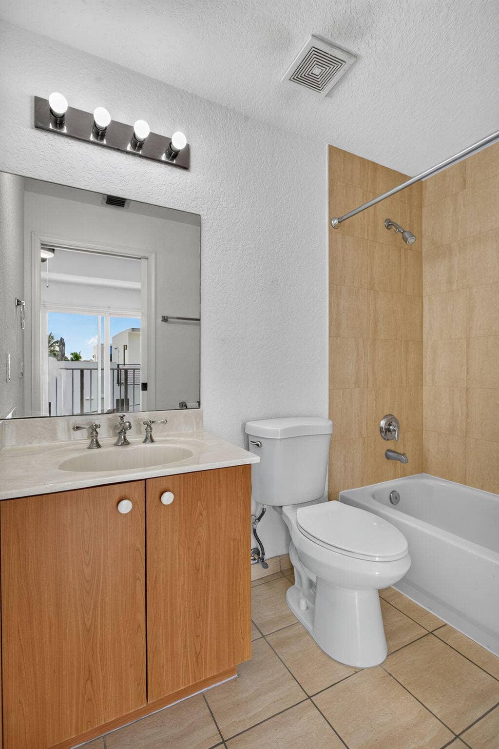 2725 NE 8TH Avenue, #112, Wilton Manors, FL 33334 Wood-finish vanity with a light-colored countertop and integrated sink
